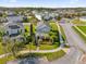 Charming two-story home featuring a meticulously landscaped yard, accented by vibrant flowers and mature palm trees at 9862 Pecan Hickory Way, Orlando, FL 32832