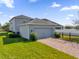 Beautiful home with a brick driveway, manicured lawn, and attached garage at 9862 Pecan Hickory Way, Orlando, FL 32832