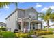 Charming two-story home featuring a manicured lawn and inviting front porch at 9862 Pecan Hickory Way, Orlando, FL 32832