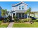 Charming two-story home with a landscaped front yard and covered porch with brick walkway at 9862 Pecan Hickory Way, Orlando, FL 32832