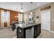 Kitchen island with granite countertop and stainless steel dishwasher overlooking dining area with lots of natural light at 9862 Pecan Hickory Way, Orlando, FL 32832