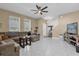 Bright living room featuring tile floors, a ceiling fan, and large windows at 9862 Pecan Hickory Way, Orlando, FL 32832