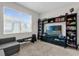 Cozy living room with large bookcase and natural light, perfect for relaxing at 9862 Pecan Hickory Way, Orlando, FL 32832