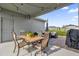 Outdoor patio with table, chairs and grill, perfect for dining and entertaining at 9862 Pecan Hickory Way, Orlando, FL 32832