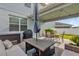 Inviting outdoor patio with lounge seating, dining area, and well-maintained landscaping at 9862 Pecan Hickory Way, Orlando, FL 32832