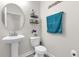 Charming powder room features pedestal sink, decorative accents, and a modern toilet at 9862 Pecan Hickory Way, Orlando, FL 32832