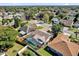 Aerial view of a home with a screened-in pool in a neighborhood setting with mature trees at 1017 Bluejack Oak Dr, Oviedo, FL 32765