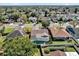 Neighborhood aerial view showcasing a home with a screened pool, lush greenery and surrounding residences at 1017 Bluejack Oak Dr, Oviedo, FL 32765