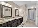 Bathroom with a double sink vanity with granite countertops and a shower with neutral tones at 1017 Bluejack Oak Dr, Oviedo, FL 32765