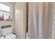 Bathroom featuring a toilet, shower/tub with neutral shower curtain, and a window above the toilet at 1017 Bluejack Oak Dr, Oviedo, FL 32765