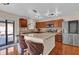 Well-lit kitchen features wood cabinets, stainless steel appliances, and granite countertops at 1017 Bluejack Oak Dr, Oviedo, FL 32765