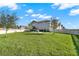 A spacious grassy backyard is fully fenced with a fire pit in the distance at 10319 Austrina Oak Loop, Winter Garden, FL 34787