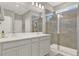 This bathroom features a double sink vanity and a large glass shower at 10319 Austrina Oak Loop, Winter Garden, FL 34787