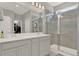 This bathroom features a double sink vanity and a large glass shower at 10319 Austrina Oak Loop, Winter Garden, FL 34787