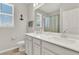 Bright bathroom with a double vanity, quartz countertop, and modern fixtures under a clear blue sky at 10319 Austrina Oak Loop, Winter Garden, FL 34787