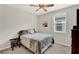 Neutral bedroom features large window, queen bed, and side tables at 10319 Austrina Oak Loop, Winter Garden, FL 34787