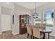 Elegant dining area with a stylish hutch, modern lighting, and large windows at 10319 Austrina Oak Loop, Winter Garden, FL 34787