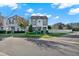 Charming two-story home with a manicured lawn and elegant gray exterior, and lush landscaping at 10319 Austrina Oak Loop, Winter Garden, FL 34787