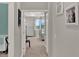 Hallway view featuring doorways and a glimpse into the Primary bedroom at 10319 Austrina Oak Loop, Winter Garden, FL 34787