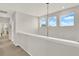 Upstairs hallway with large windows offers plenty of natural light at 10319 Austrina Oak Loop, Winter Garden, FL 34787