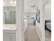 Hallway showcasing the bathroom vanity, a cozy sitting area, and a bedroom at 10319 Austrina Oak Loop, Winter Garden, FL 34787