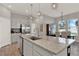 Modern kitchen island with granite countertops, stainless steel appliances, and an open design at 10319 Austrina Oak Loop, Winter Garden, FL 34787