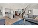 Open-concept living room flows into the dining room and kitchen with a staircase leading to the second floor at 10319 Austrina Oak Loop, Winter Garden, FL 34787