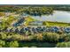 An aerial view showcases this neighborhood's lovely homes nestled near a scenic lake and lush greenery at 1208 Patterson Ter, Lake Mary, FL 32746