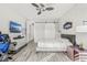 Comfortable bedroom featuring light wood-look floors, neutral decor, a ceiling fan, and a sliding closet door at 1208 Patterson Ter, Lake Mary, FL 32746