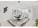 Dining area featuring a black table, modern chairs, artistic decor, and a contemporary light fixture at 1208 Patterson Ter, Lake Mary, FL 32746