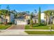 Home exterior with mature landscaping, a brick driveway, a two-car garage, and a beautifully maintained lawn at 1208 Patterson Ter, Lake Mary, FL 32746