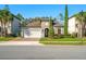 Charming one-story home features a manicured front yard, brick driveway, and a two-car garage at 1208 Patterson Ter, Lake Mary, FL 32746