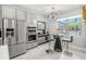 Bright breakfast nook featuring stainless steel appliances, a modern chandelier and views to the outdoors at 1208 Patterson Ter, Lake Mary, FL 32746