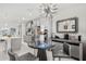 Stylish breakfast nook area with views into the main kitchen featuring stainless appliances and gray cabinets at 1208 Patterson Ter, Lake Mary, FL 32746