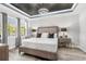 Calming main bedroom featuring soft colors, wood floors, large windows, and stylish decor at 1208 Patterson Ter, Lake Mary, FL 32746