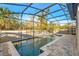 Sparkling screened pool with soothing water feature and stone coping, set against a lush backdrop at 1208 Patterson Ter, Lake Mary, FL 32746