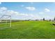 Community soccer field for neighborhood residents with green grass under a partly cloudy sky at 1218 Normandy Dr, Haines City, FL 33844