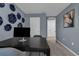 Serene home office with blue walls, decorative wall plates, and a modern black desk at 1337 Fan Palm Dr, Davenport, FL 33897