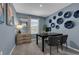 Serene home office with blue walls, decorative wall plates, and a modern black desk at 1337 Fan Palm Dr, Davenport, FL 33897