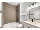 Bathroom featuring a shower-tub combo with elegant tiling and modern fixtures at 16074 Sw 49Th Court Rd, Ocala, FL 34473