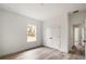 Light-filled bedroom featuring wood-look floors and a double closet at 16074 Sw 49Th Court Rd, Ocala, FL 34473