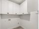 Well-lit laundry room features white cabinets and sleek fixtures at 16074 Sw 49Th Court Rd, Ocala, FL 34473