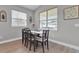 Cozy dining area with wood-look tile floors, natural light, and seating for six at 1660 5 Ave, Deland, FL 32724