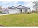 Attractive one-story home featuring a lush green lawn, a two-car garage, and a welcoming front entrance at 1660 5 Ave, Deland, FL 32724