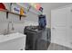 Modern laundry room features stainless steel sink, new washer and dryer, and natural light at 1660 5 Ave, Deland, FL 32724