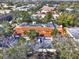 Aerial view of a property with a red tile roof, surrounded by lush trees at 176 Balfour Dr # 4, Winter Park, FL 32792