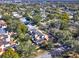 An aerial view showcases a charming community surrounded by mature trees and blue skies at 176 Balfour Dr # 4, Winter Park, FL 32792