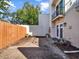 Backyard patio area with a wooden fence and partial view of the two-story house at 176 Balfour Dr # 4, Winter Park, FL 32792