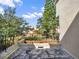 View from the balcony of a backyard with trees and a fence under a blue sky at 176 Balfour Dr # 4, Winter Park, FL 32792