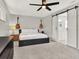 Neutral bedroom with guitars displayed on the wall, barn door and ceiling fan at 176 Balfour Dr # 4, Winter Park, FL 32792